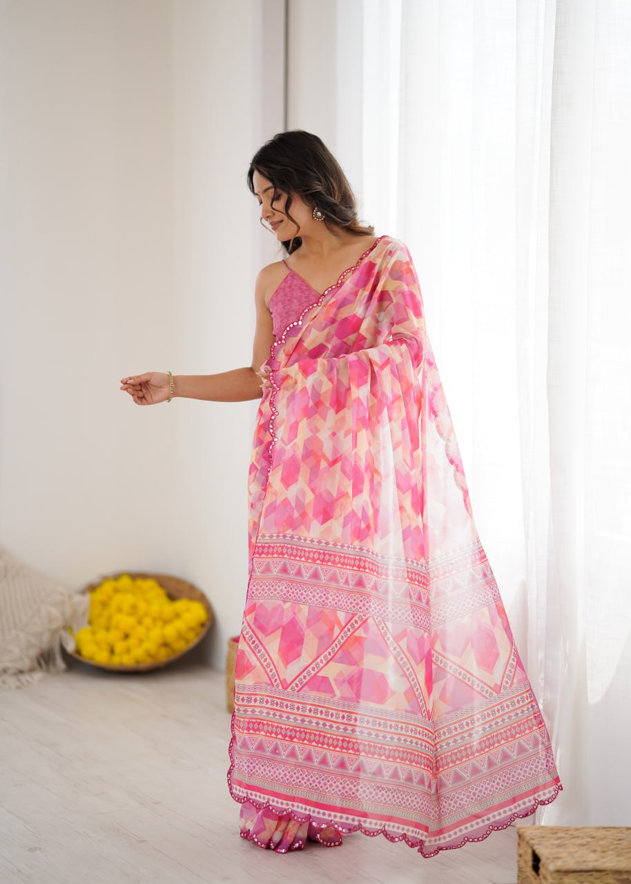 Pink color georgette saree with printed and mirror work border