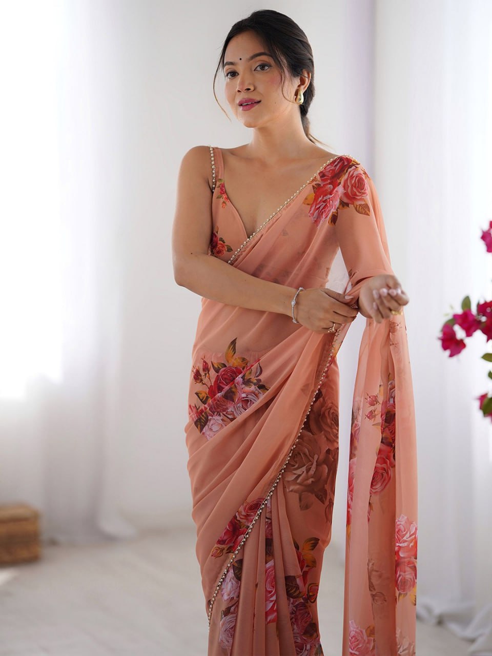 Peach color georgette saree with printed work and pearl border