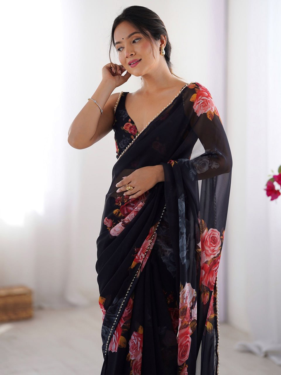 Black color georgette saree with printed work and pearl border
