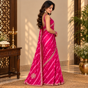 Close-up of zardosi border and golden motifs on the pink leheriya saree

