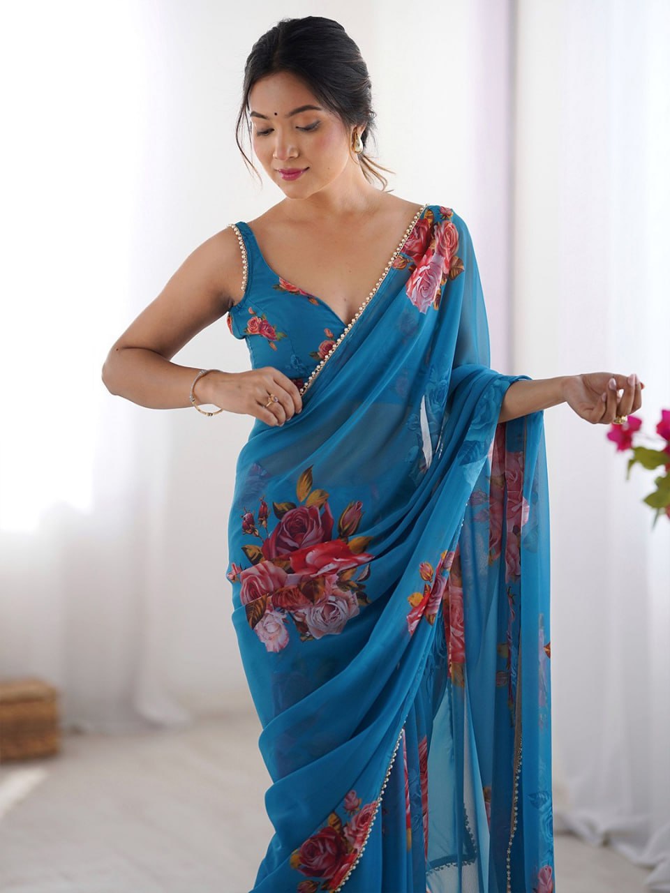 Blue color georgette saree with printed work and pearl border