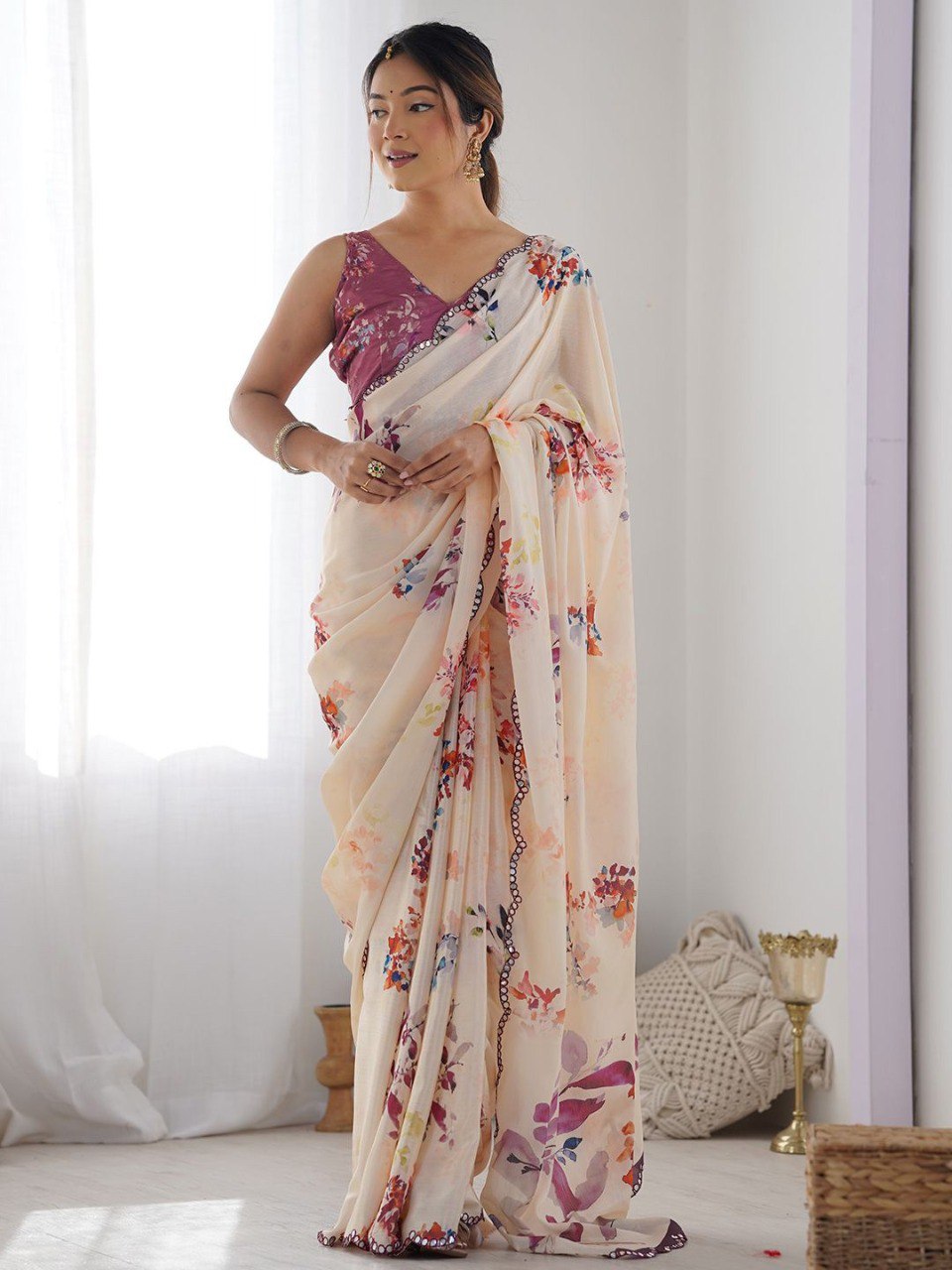 Beige color georgette saree with printed and mirror work border