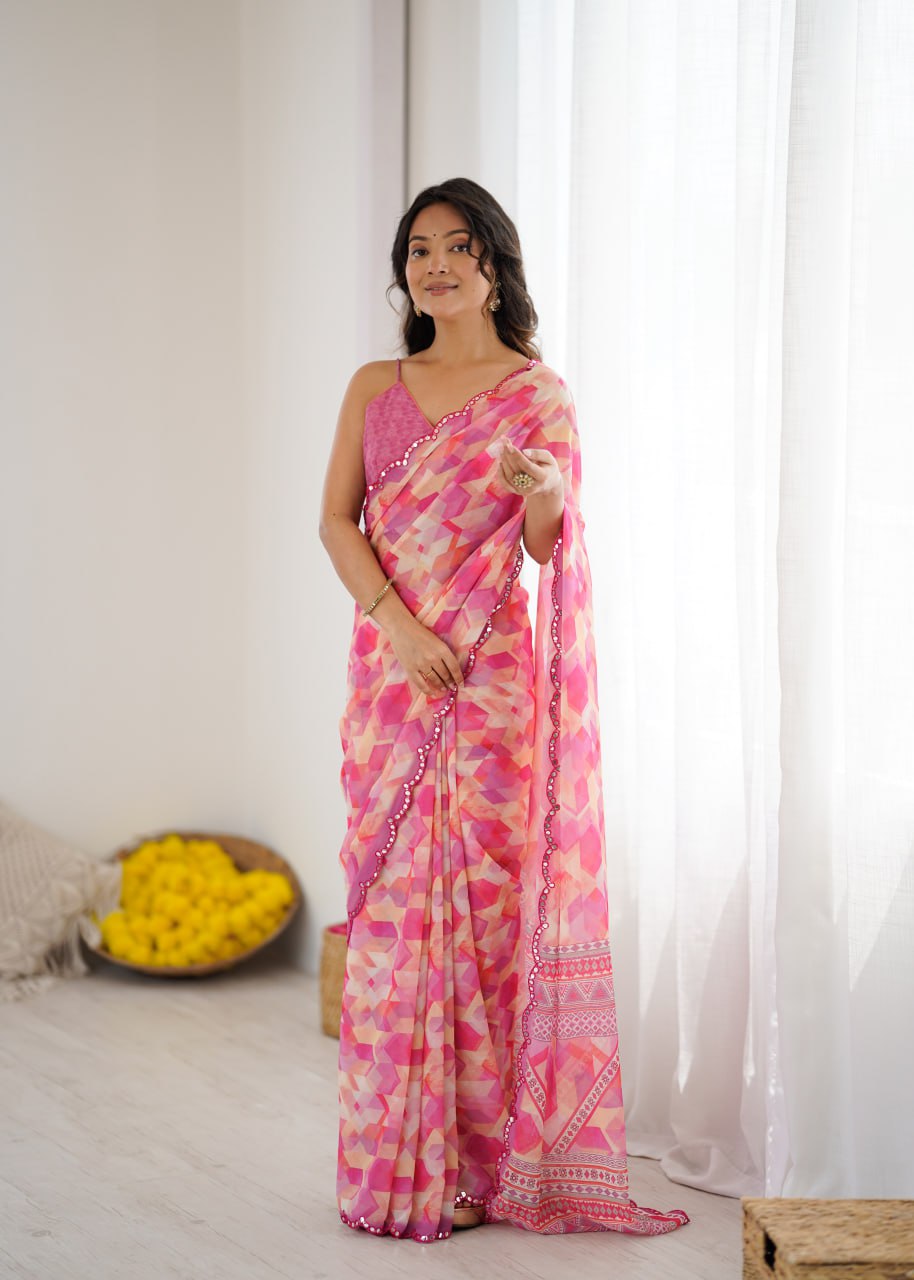 Pink color georgette saree with printed and mirror work border