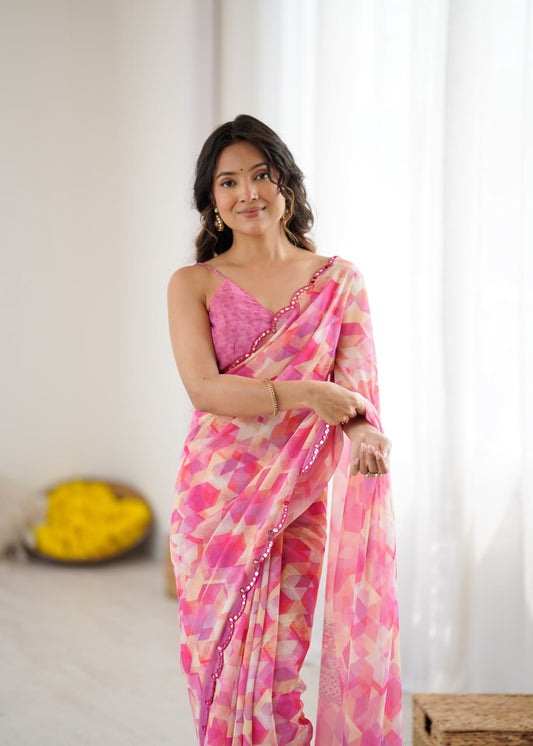 Pink color georgette saree with printed and mirror work border