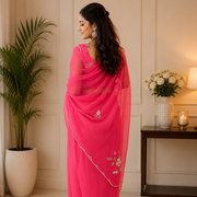 Peach georgette saree draped to show the flowing pallu