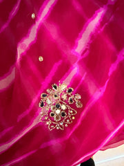 Pink leheriya saree draped to show the fuchsia tie-dye pattern