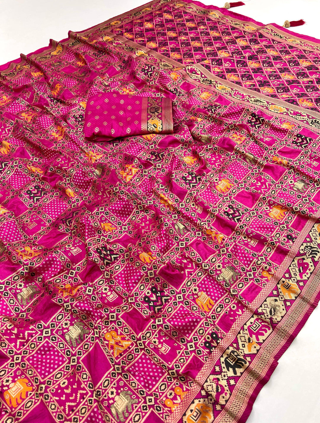 Rani pink patola silk saree with meenakari zari weaving work.
