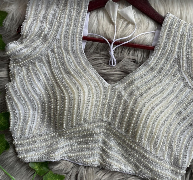White soft silk readymade blouse with handcrafted pearl work.