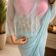 Sky blue georgette saree draped to show the flowing pallu