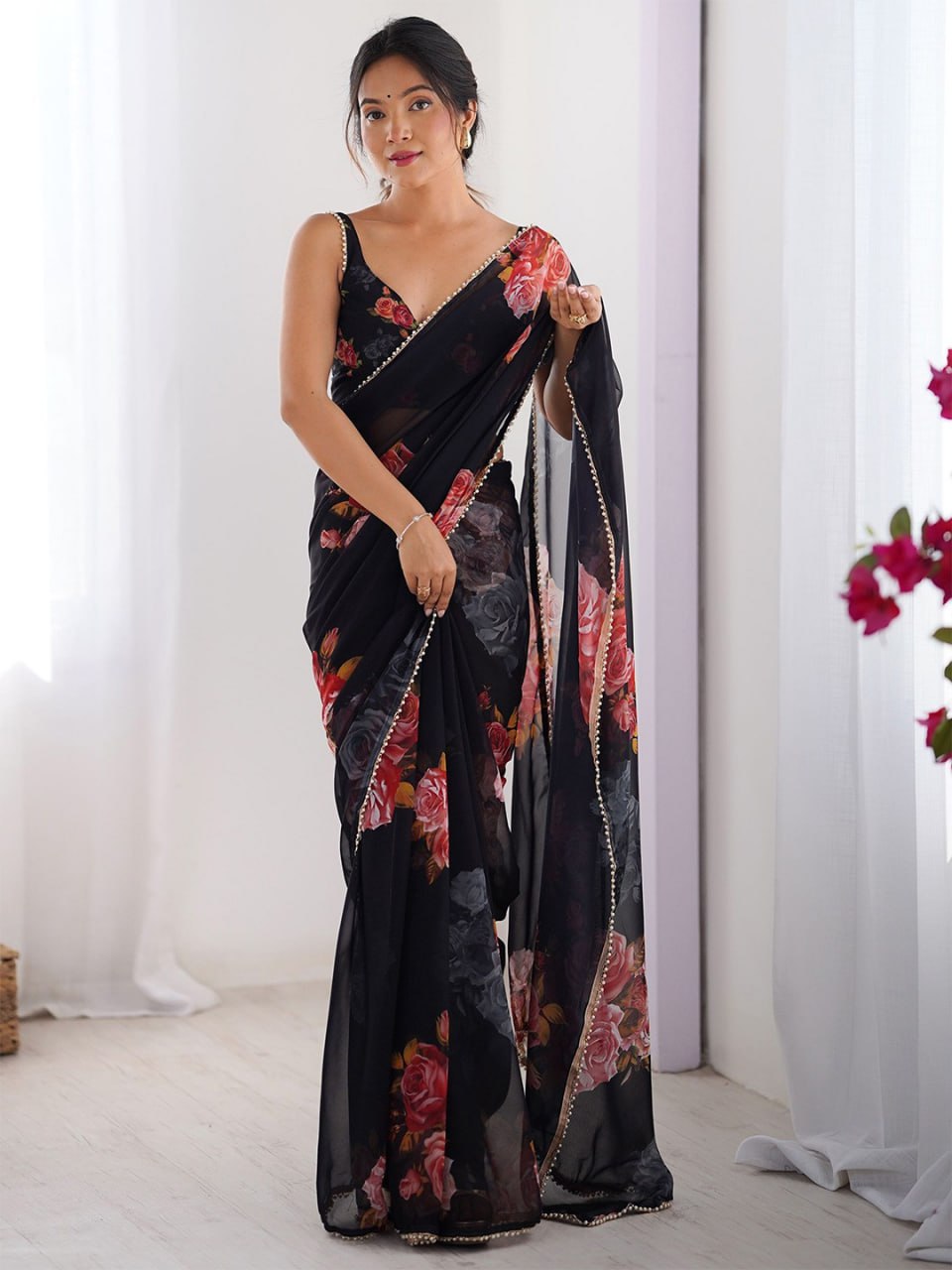 Black color georgette saree with printed work and pearl border