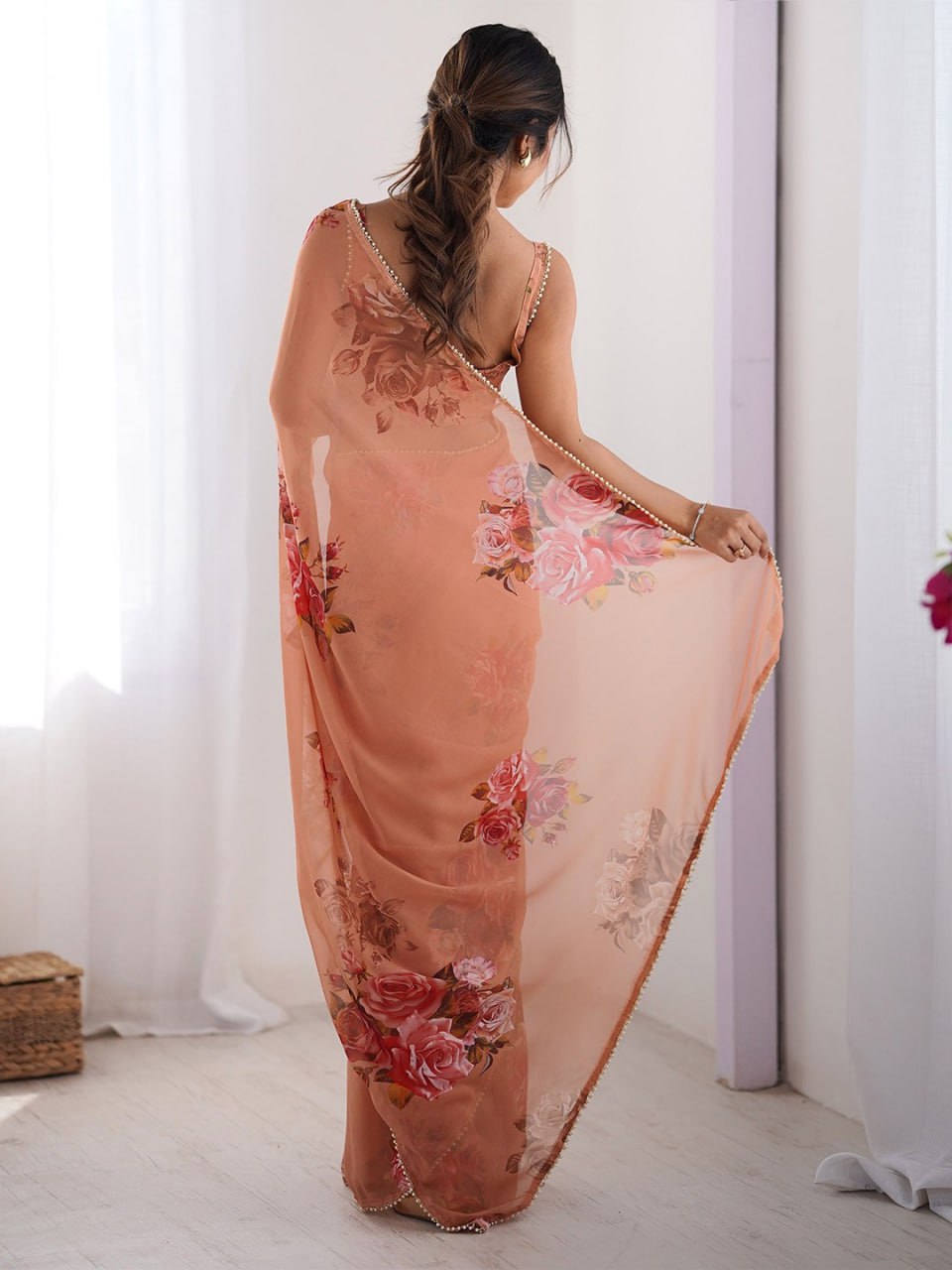 Peach color georgette saree with printed work and pearl border