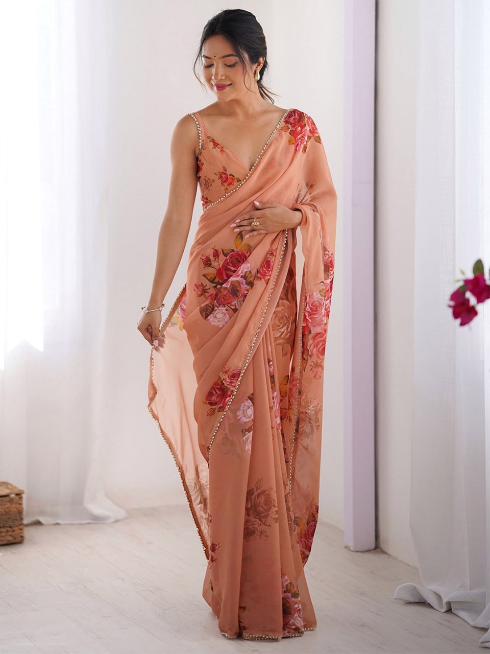 Peach color georgette saree with printed work and pearl border